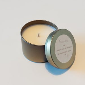 Lumânare parfumată Veraroma, model Alba la 90g deschisă, cu capacul sprijinit de cutia metalică aurie. Arome de pară aurie, frezie albă și mosc.